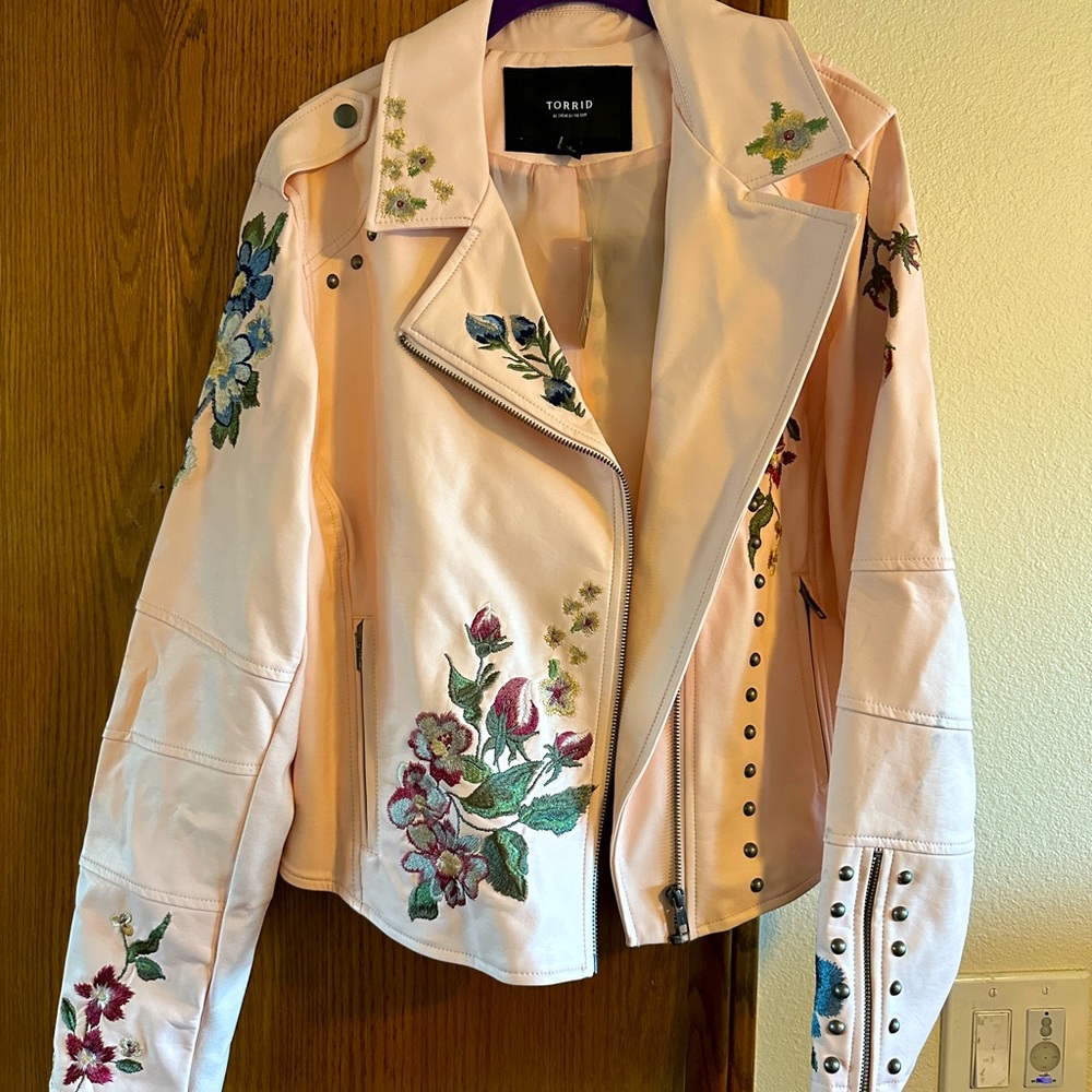 Torrid pink women’s faux leather jacket with embroidery and round metal studs.